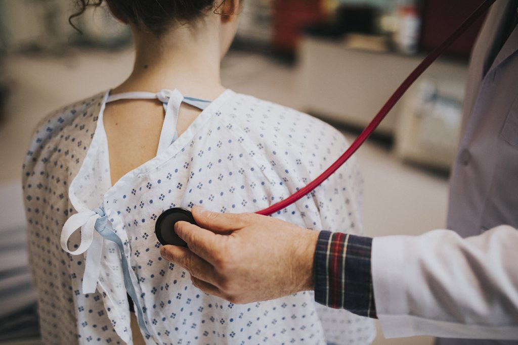 Doctor Listening to Teen's Lung